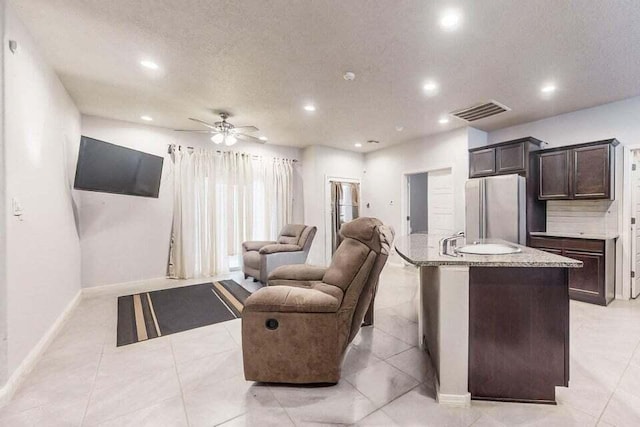1472 Tierra Verde Loop, Los Lunas, NM 87031 - living area featuring recessed lighting, baseboards, ceiling fan, and a textured ceiling