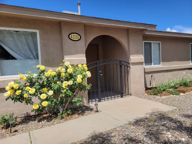 4235 Pumice Dr NE, Rio Rancho, NM 87124 - doorway to property featuring a gate and stucco siding