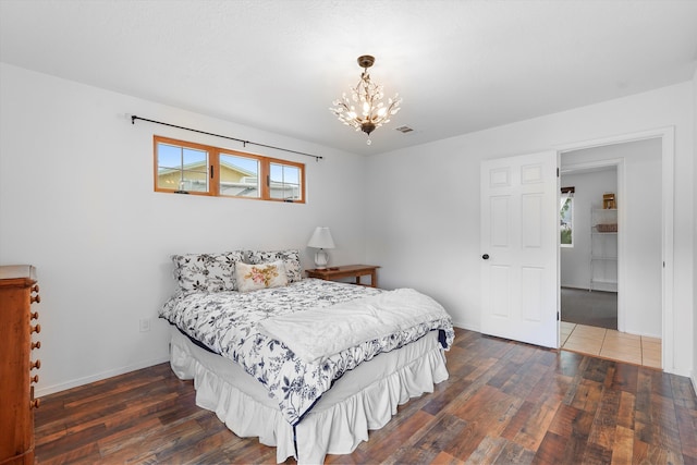 4235 Pumice Dr NE, Rio Rancho, NM 87124 - bedroom featuring wood finished floors, a chandelier, and baseboards