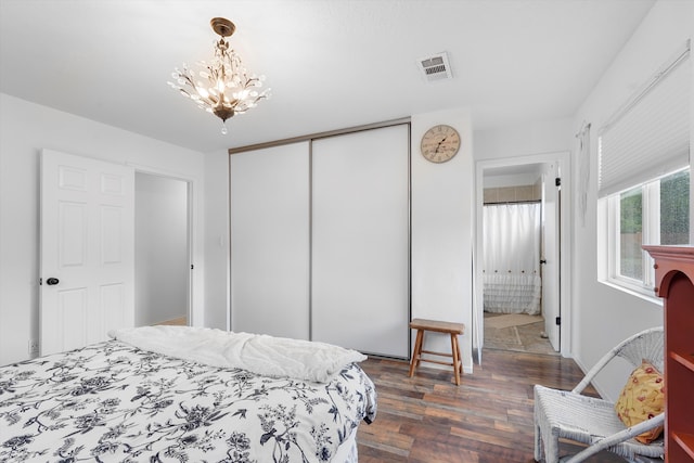4235 Pumice Dr NE, Rio Rancho, NM 87124 - bedroom featuring dark wood-style flooring, a chandelier, and a closet