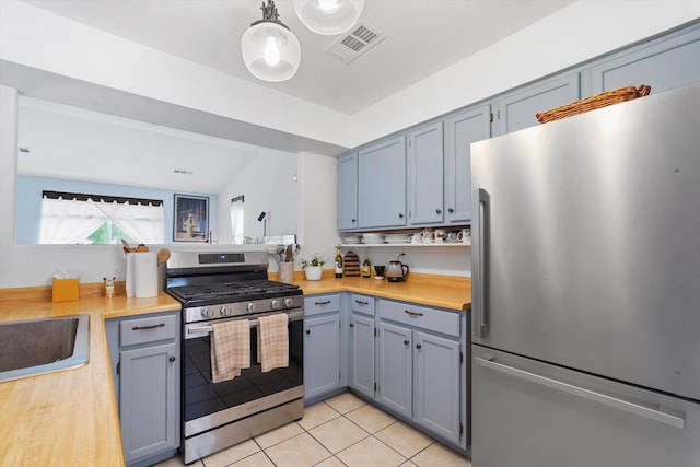 4235 Pumice Dr NE, Rio Rancho, NM 87124 - kitchen with appliances with stainless steel finishes, light countertops, light tile patterned floors, and a sink