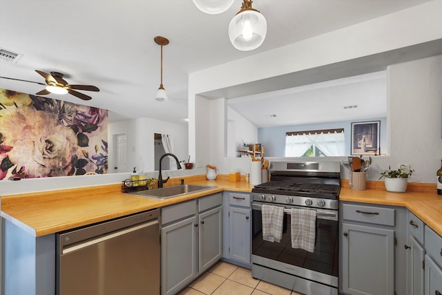 4235 Pumice Dr NE, Rio Rancho, NM 87124 - kitchen featuring appliances with stainless steel finishes, a sink, gray cabinets, light tile patterned floors, and light countertops