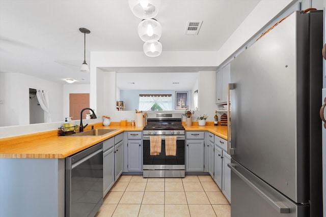4235 Pumice Dr NE, Rio Rancho, NM 87124 - kitchen with stainless steel appliances, a sink, gray cabinets, and light tile patterned floors