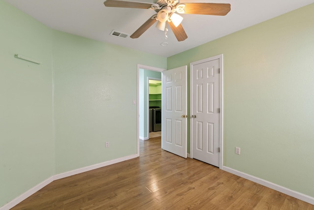 9200 Saguaro St NW, Albuquerque, NM 87114 - unfurnished bedroom featuring baseboards, light wood-style floors, washer / dryer, ceiling fan, and a closet