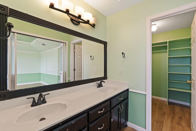 9200 Saguaro St NW, Albuquerque, NM 87114 - bathroom with double vanity, wood finished floors, and baseboards