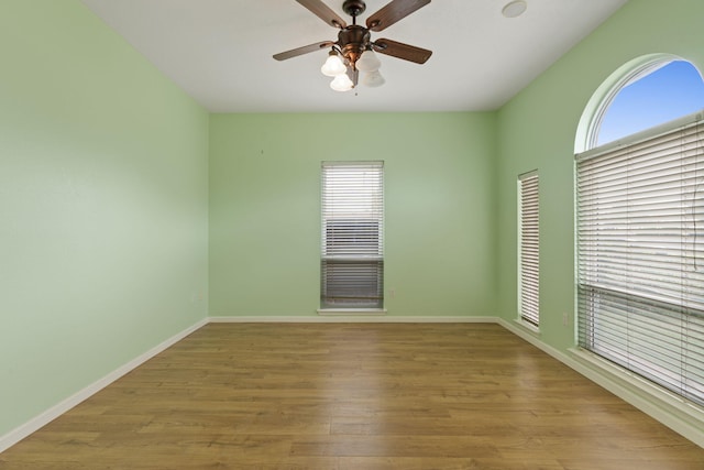 9200 Saguaro St NW, Albuquerque, NM 87114 - empty room with wood finished floors, a ceiling fan, and baseboards