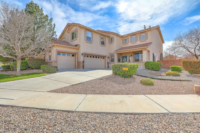 10451 Venticello Dr NW, Albuquerque, NM 87114 - mediterranean / spanish home featuring a garage, stucco siding, driveway, a tiled roof, and stone siding