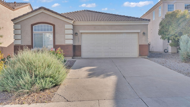 1023 Marapi St NW, Albuquerque, NM 87120 - view of front facade featuring driveway, stucco siding, a garage, and a tile roof