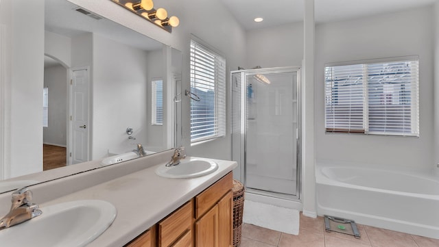 1023 Marapi St NW, Albuquerque, NM 87120 - full bathroom with a stall shower, a bath, double vanity, and tile patterned floors