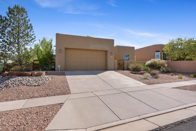 4612 Cactus Ave NW, Albuquerque, NM 87114 - pueblo revival-style home featuring concrete driveway, stucco siding, and a garage