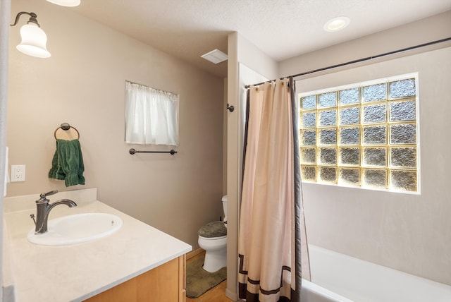 4612 Cactus Ave NW, Albuquerque, NM 87114 - bathroom featuring toilet, plenty of natural light, vanity, and a textured ceiling