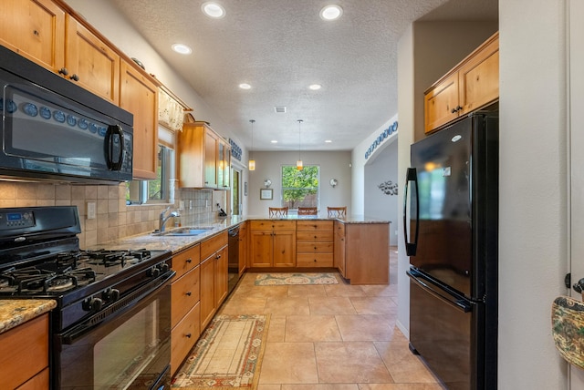 4612 Cactus Ave NW, Albuquerque, NM 87114 - kitchen with black appliances, a peninsula, a sink, light stone counters, and recessed lighting