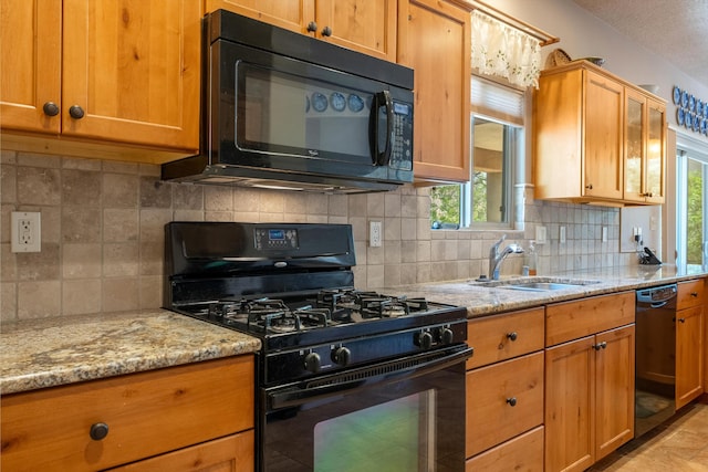 4612 Cactus Ave NW, Albuquerque, NM 87114 - kitchen featuring black appliances, a sink, light stone countertops, and tasteful backsplash