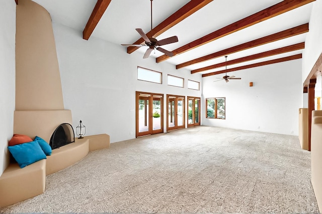 1704 Quail Run Ct NE, Albuquerque, NM 87122 - unfurnished living room with ceiling fan, carpet floors, beam ceiling, and a towering ceiling