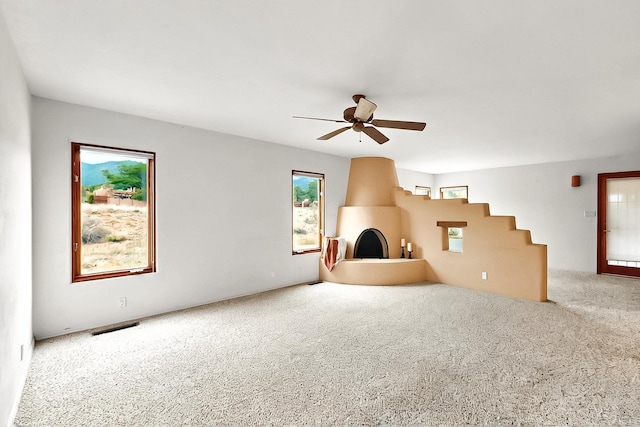 1704 Quail Run Ct NE, Albuquerque, NM 87122 - unfurnished living room with carpet floors, plenty of natural light, and a ceiling fan