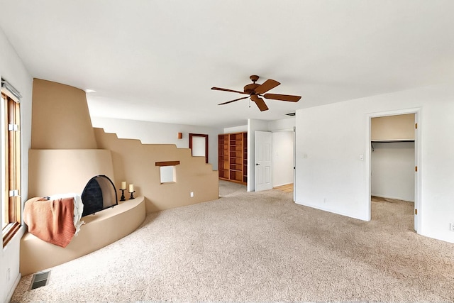 1704 Quail Run Ct NE, Albuquerque, NM 87122 - unfurnished living room featuring light colored carpet, ceiling fan, and healthy amount of natural light