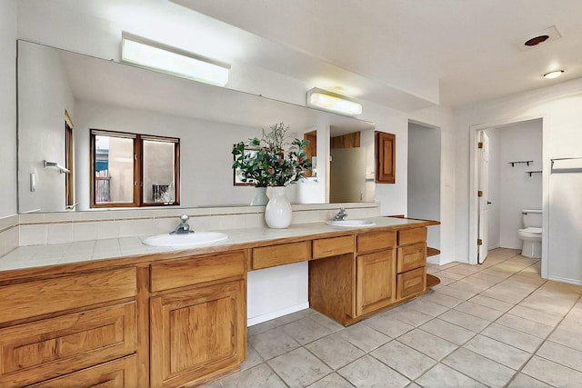1704 Quail Run Ct NE, Albuquerque, NM 87122 - bathroom featuring tile patterned floors, double vanity, and toilet