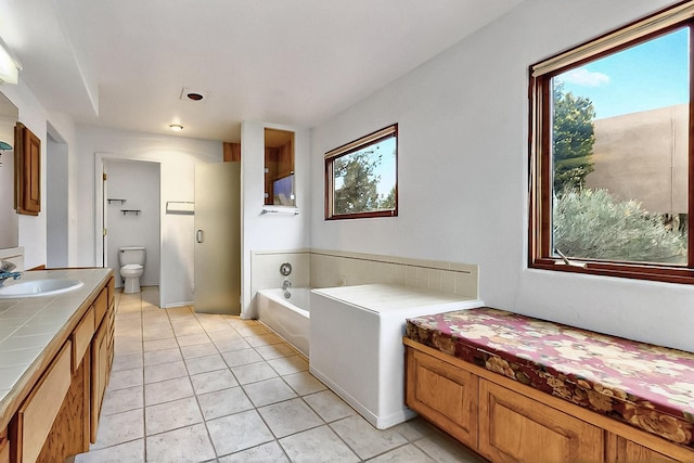 1704 Quail Run Ct NE, Albuquerque, NM 87122 - full bath featuring a bath, vanity, tile patterned flooring, and toilet