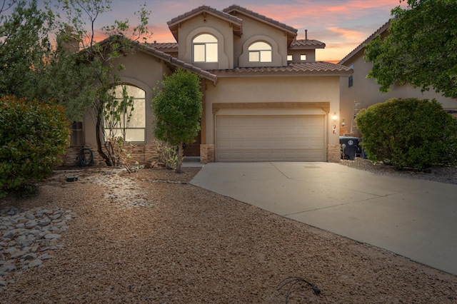 4848 Petra Pointe Cir NW, Albuquerque, NM 87120 - mediterranean / spanish house featuring stucco siding, concrete driveway, an attached garage, and a tile roof