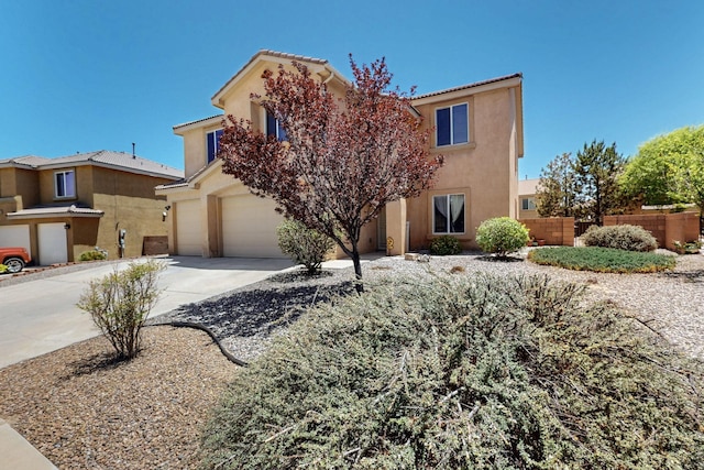 1412 Wind Ridge Dr NW, Albuquerque, NM 87120 - view of front of property featuring a garage, concrete driveway, and stucco siding