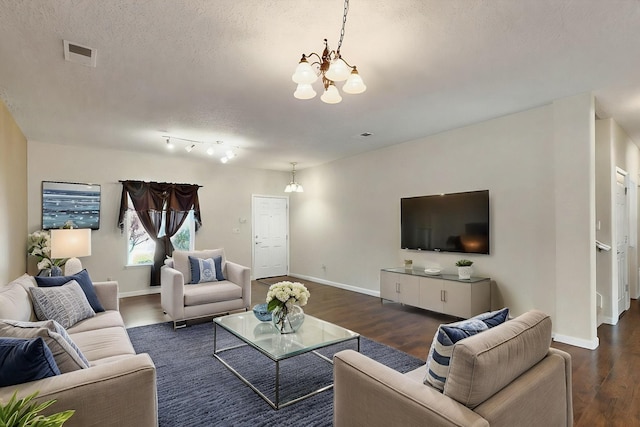 1412 Wind Ridge Dr NW, Albuquerque, NM 87120 - living area with a chandelier, dark wood finished floors, and a textured ceiling