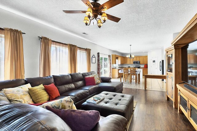 1412 Wind Ridge Dr NW, Albuquerque, NM 87120 - living room featuring a textured ceiling, ceiling fan, and hardwood / wood-style flooring