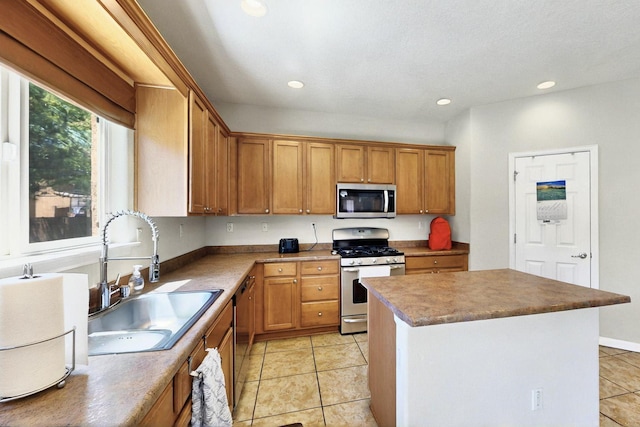 1412 Wind Ridge Dr NW, Albuquerque, NM 87120 - kitchen featuring stainless steel appliances, recessed lighting, light tile patterned floors, a center island, and brown cabinetry