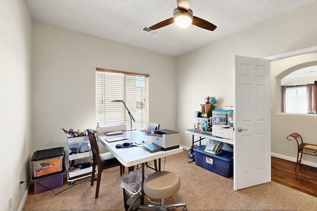 1412 Wind Ridge Dr NW, Albuquerque, NM 87120 - home office with a ceiling fan, arched walkways, carpet floors, and a textured ceiling