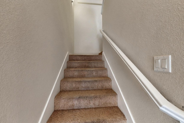 1412 Wind Ridge Dr NW, Albuquerque, NM 87120 - staircase featuring a textured wall