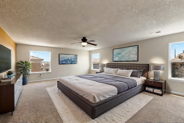 1412 Wind Ridge Dr NW, Albuquerque, NM 87120 - bedroom with light colored carpet, a textured ceiling, and ceiling fan