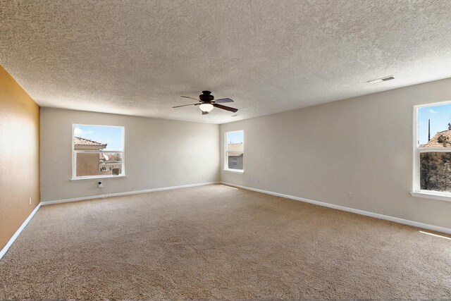 1412 Wind Ridge Dr NW, Albuquerque, NM 87120 - carpeted spare room with ceiling fan and a textured ceiling