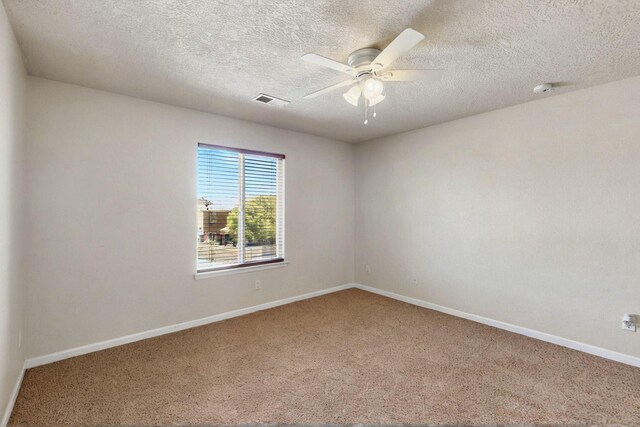 1412 Wind Ridge Dr NW, Albuquerque, NM 87120 - spare room featuring carpet floors, ceiling fan, a textured ceiling, and a smoke detector