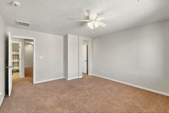 1412 Wind Ridge Dr NW, Albuquerque, NM 87120 - unfurnished bedroom with carpet floors, arched walkways, a textured ceiling, and ceiling fan
