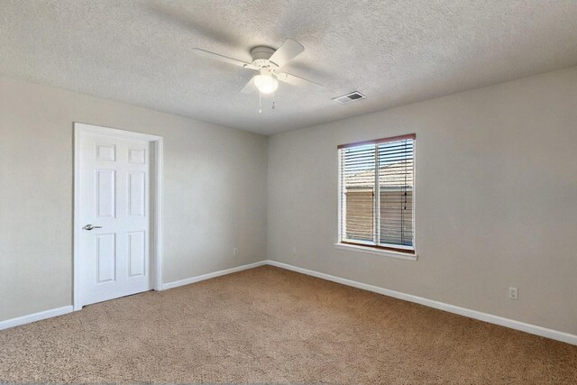 1412 Wind Ridge Dr NW, Albuquerque, NM 87120 - spare room featuring carpet, a ceiling fan, and a textured ceiling