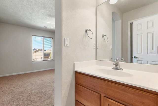 1412 Wind Ridge Dr NW, Albuquerque, NM 87120 - bathroom featuring vanity and a textured ceiling