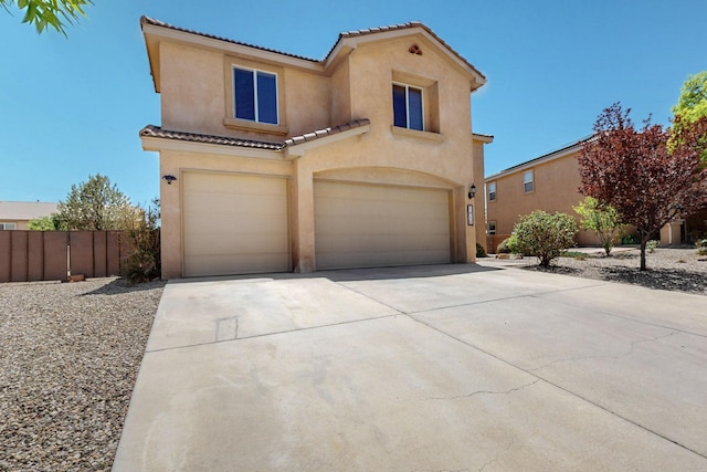 1412 Wind Ridge Dr NW, Albuquerque, NM 87120 - mediterranean / spanish-style home with stucco siding, a tile roof, a garage, and driveway