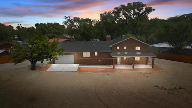 2212 Henry Rd SW, Albuquerque, NM 87105 - view of front facade featuring driveway, a chimney, and an attached garage