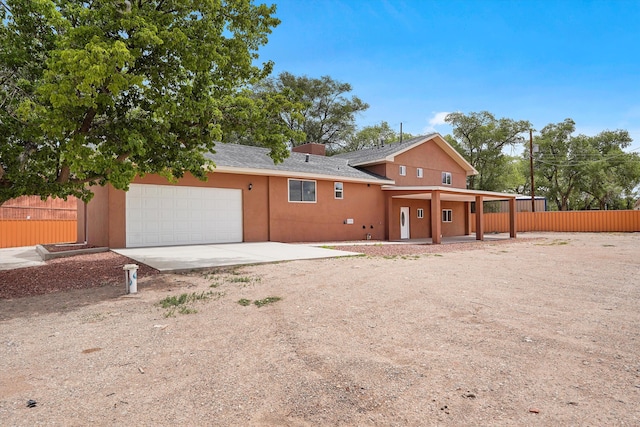 2212 Henry Rd SW, Albuquerque, NM 87105 - view of front of house with an attached garage, concrete driveway, and a shingled roof