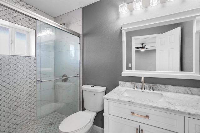 2212 Henry Rd SW, Albuquerque, NM 87105 - bathroom with vanity, toilet, ceiling fan, and a shower stall