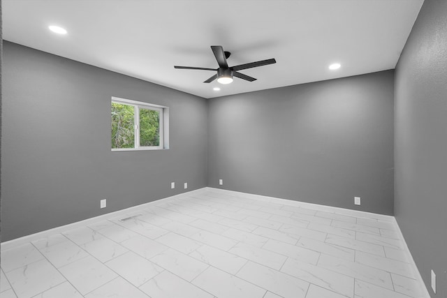 2212 Henry Rd SW, Albuquerque, NM 87105 - spare room featuring a ceiling fan, marble finish flooring, baseboards, and recessed lighting