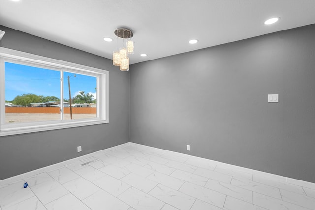 2212 Henry Rd SW, Albuquerque, NM 87105 - empty room with baseboards, marble finish floors, a chandelier, and recessed lighting