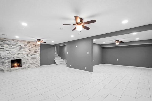 2212 Henry Rd SW, Albuquerque, NM 87105 - finished below grade area with recessed lighting, ceiling fan, stairs, a tiled fireplace, and baseboards