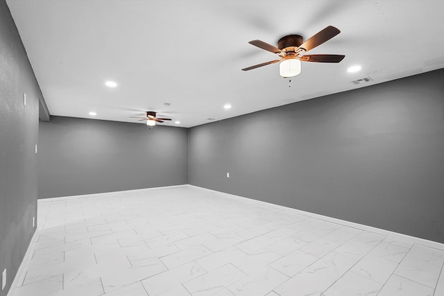 2212 Henry Rd SW, Albuquerque, NM 87105 - spare room with a ceiling fan, marble look tiles, recessed lighting, and baseboards
