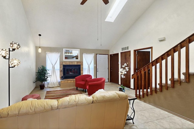 3039 Prenda De Oro Dr NW, Albuquerque, NM 87120 - living area with high vaulted ceiling, ceiling fan, a fireplace, light tile patterned flooring, and a skylight