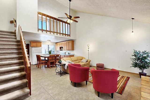 3039 Prenda De Oro Dr NW, Albuquerque, NM 87120 - living room featuring stairway, ceiling fan, a textured ceiling, light tile patterned floors, and high vaulted ceiling