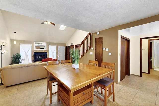 3039 Prenda De Oro Dr NW, Albuquerque, NM 87120 - dining room with a ceiling fan, light tile patterned floors, stairs, vaulted ceiling, and a textured ceiling