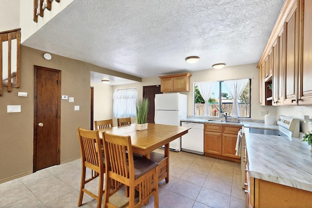 3039 Prenda De Oro Dr NW, Albuquerque, NM 87120 - kitchen featuring white appliances, a sink, light countertops, and light tile patterned floors