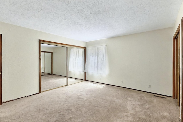3039 Prenda De Oro Dr NW, Albuquerque, NM 87120 - unfurnished bedroom featuring carpet, a closet, and a textured ceiling