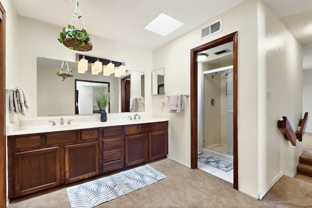 3039 Prenda De Oro Dr NW, Albuquerque, NM 87120 - bathroom with a skylight, a stall shower, double vanity, and tile patterned floors