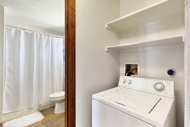 3039 Prenda De Oro Dr NW, Albuquerque, NM 87120 - washroom featuring washer / clothes dryer, light tile patterned floors, and a textured wall